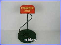Old Pflueger bait fishing lure store display stand with a wood base